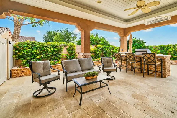 a building outdoor space with patio furniture and potted plants
