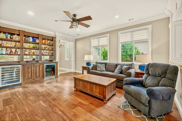 a living room with furniture a window and a flat screen tv