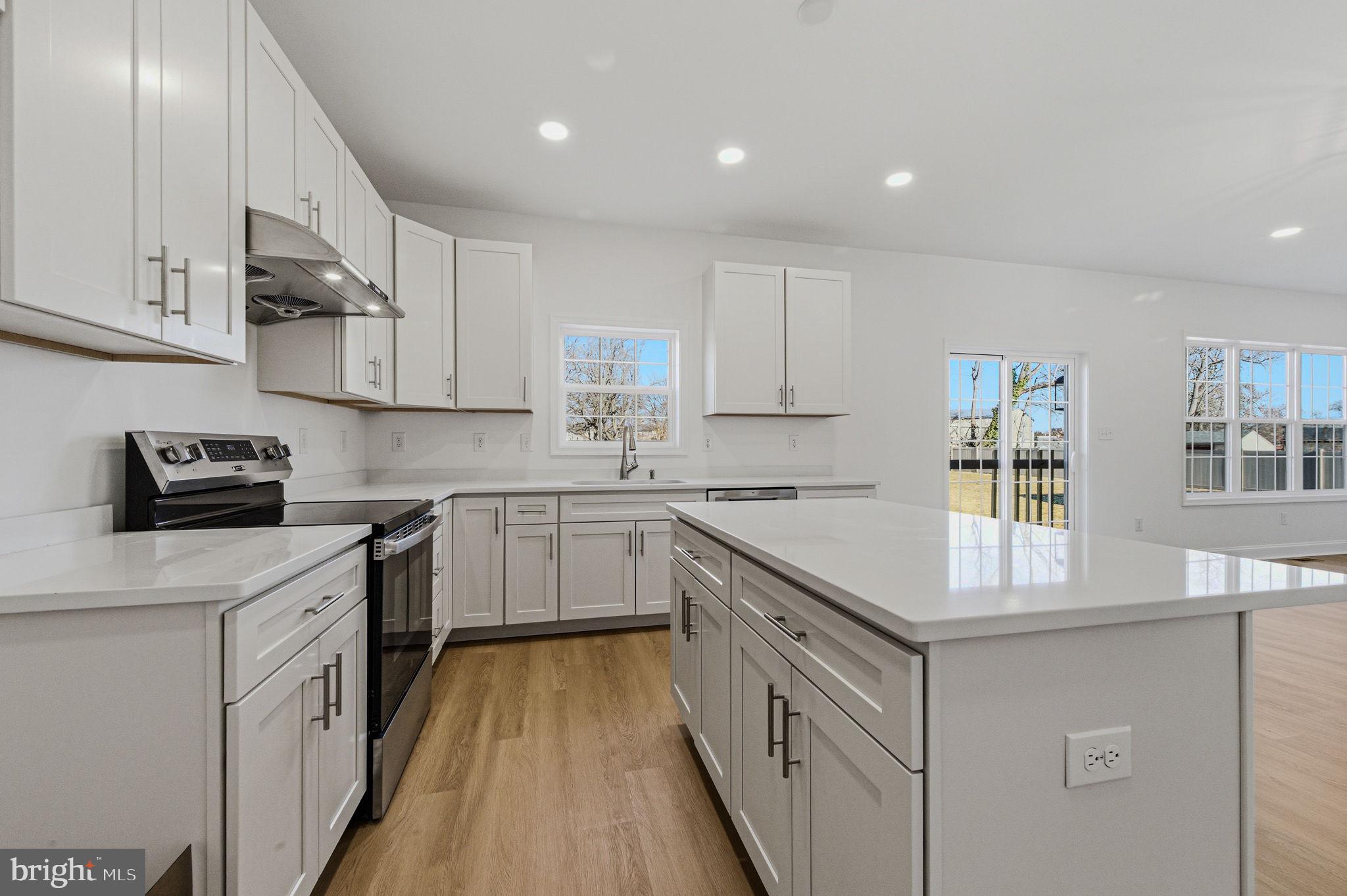 2503 A Duncan Road Wilmington, DE 19808 - Photo 16 of 41 a kitchen with cabinets wooden floor and stainless steel appliances