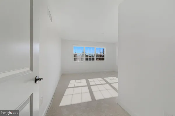 a view of an empty room and a window