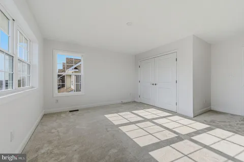 a view of an empty room with windows