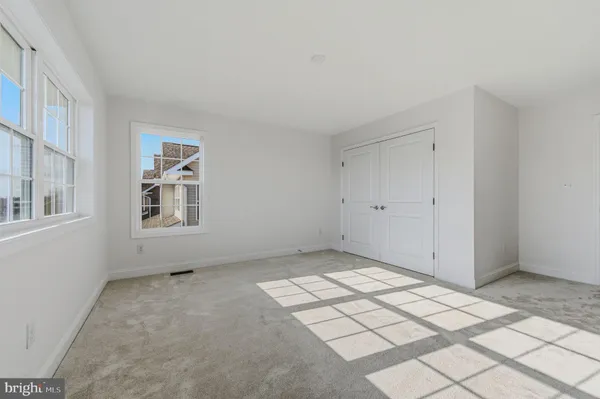 a view of an empty room with windows