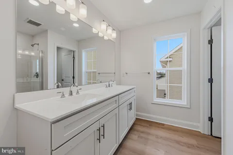 a bathroom with a sink double vanity and a mirror