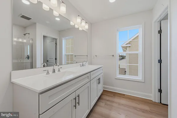 a bathroom with a sink double vanity and a mirror