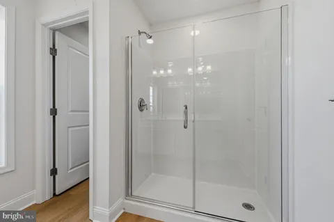 a bathroom with a glass door shower
