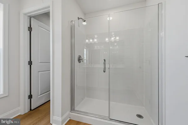 a bathroom with a glass door shower
