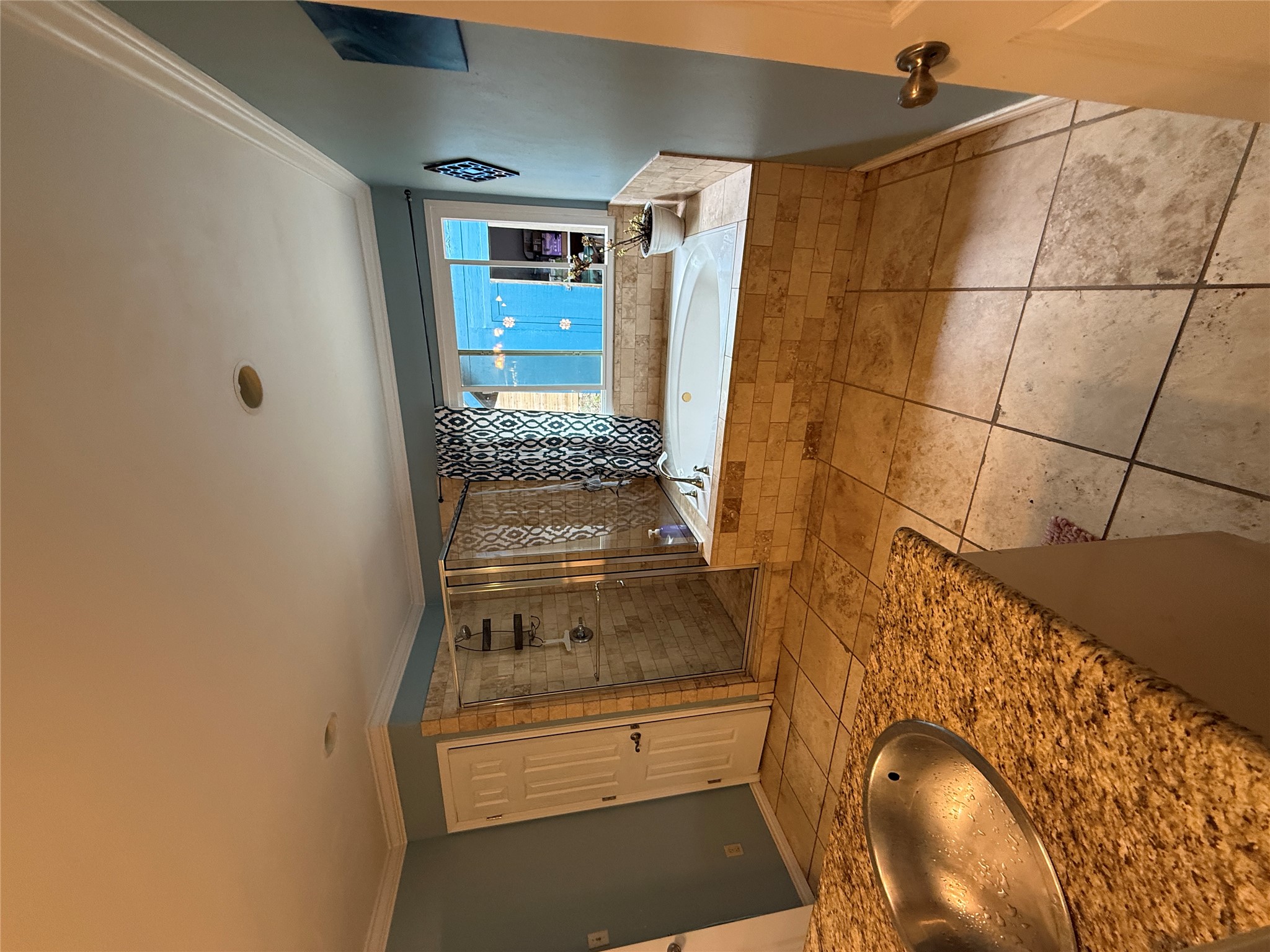7501 West Gate Boulevard Austin, TX 78745 - Photo 12 of 33 Bathroom featuring a bath, a shower stall, vanity, crown molding, and light tile patterned floors