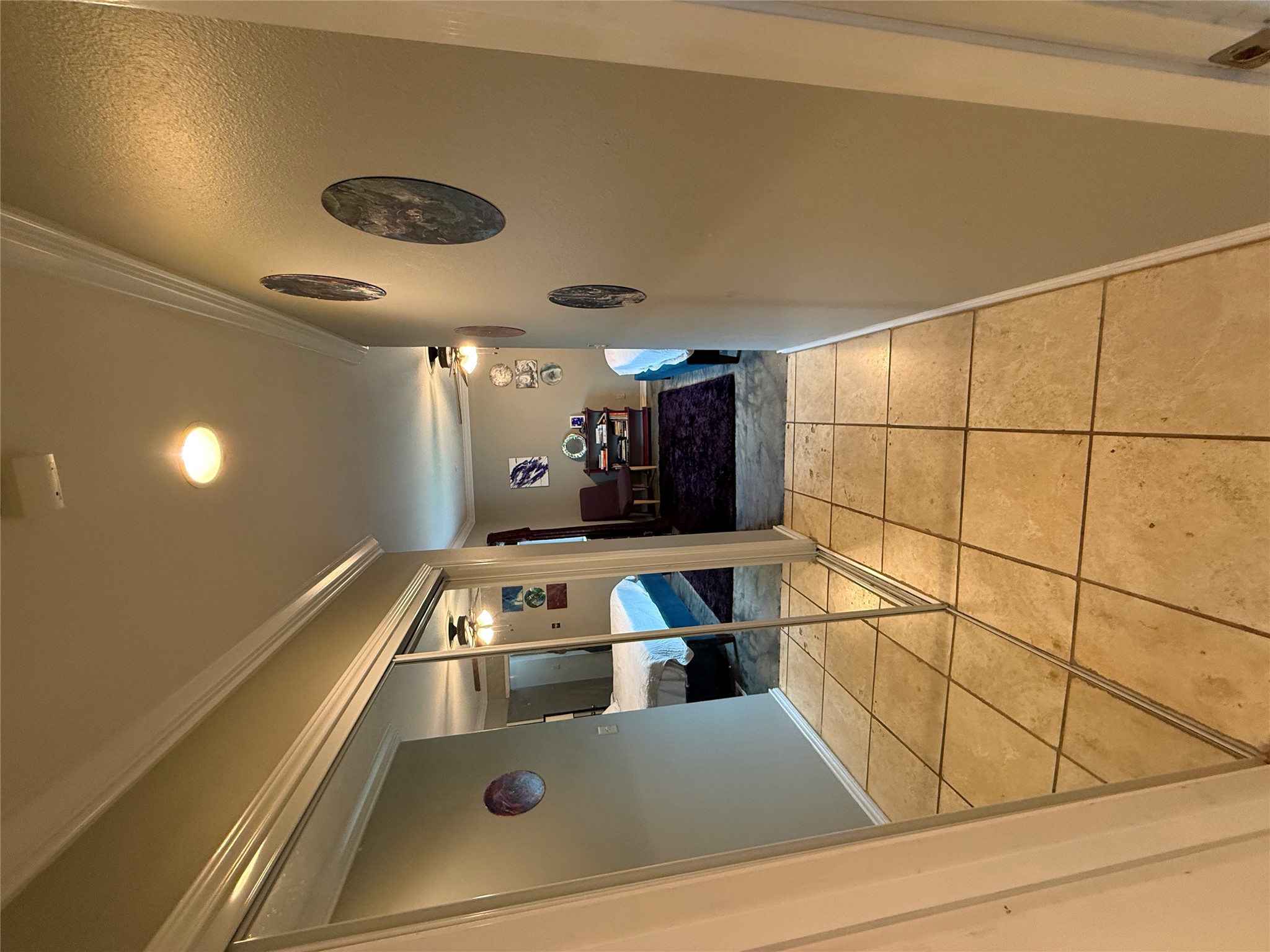 7501 West Gate Boulevard Austin, TX 78745 - Photo 15 of 33 Hall with crown molding and light tile patterned flooring