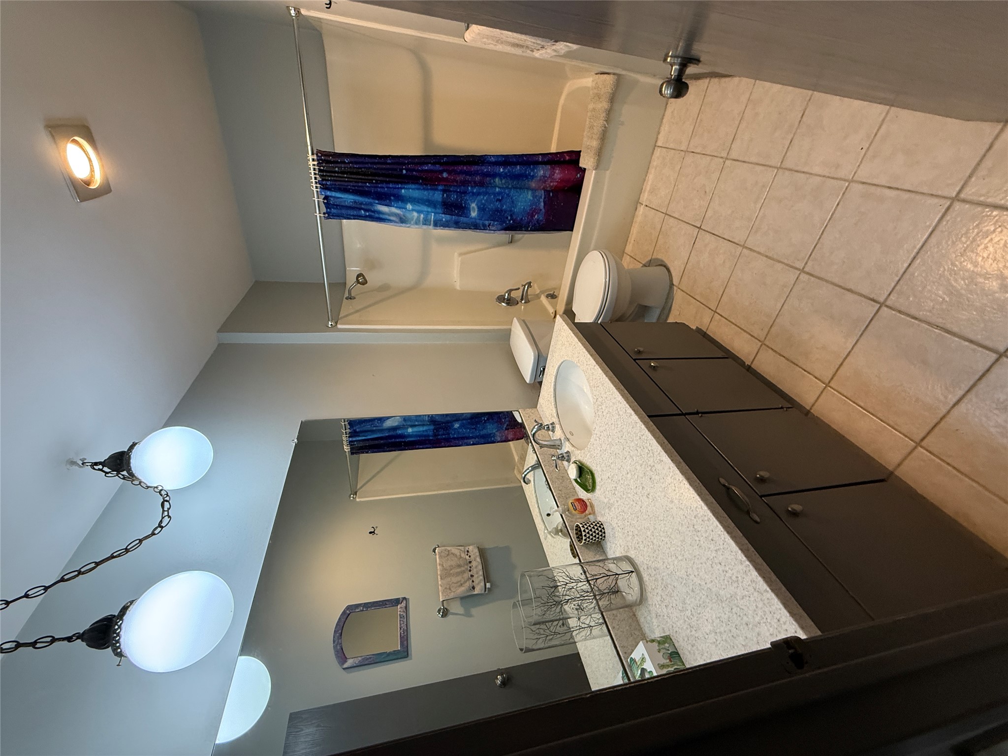 7501 West Gate Boulevard Austin, TX 78745 - Photo 18 of 33 Bathroom with vanity, shower / tub combo with curtain, and light tile patterned floors