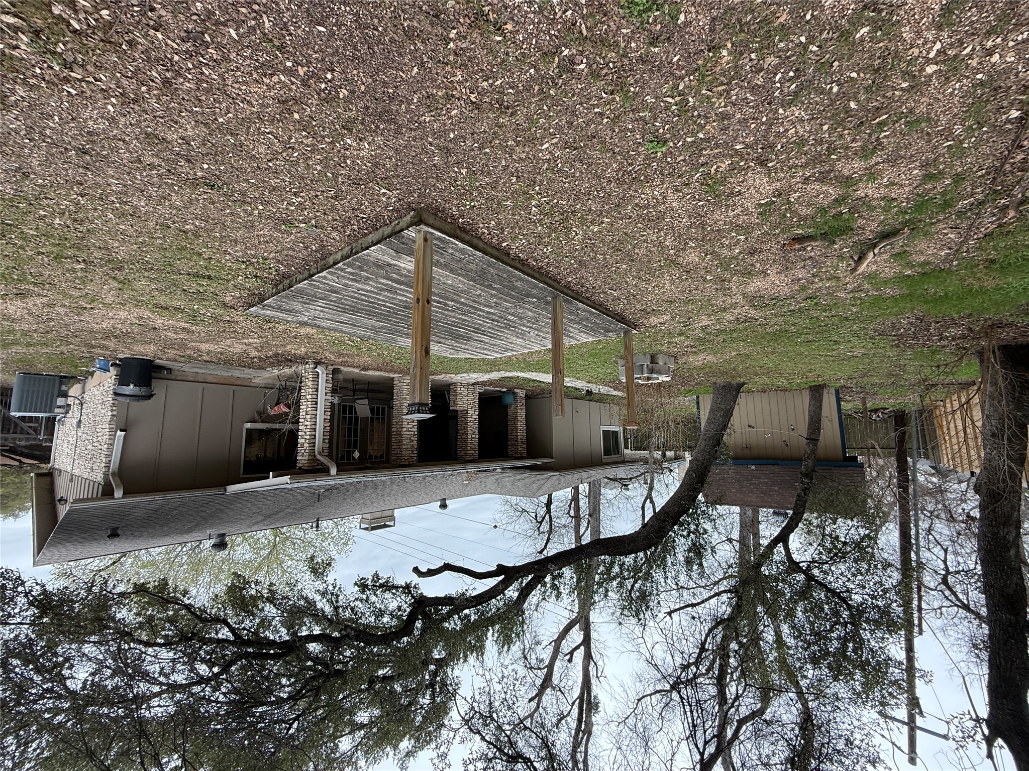 7501 West Gate Boulevard Austin, TX 78745 - Photo 23 of 33 Back of house featuring a patio, a storage shed, board and batten siding, a chimney, and a shingled roof