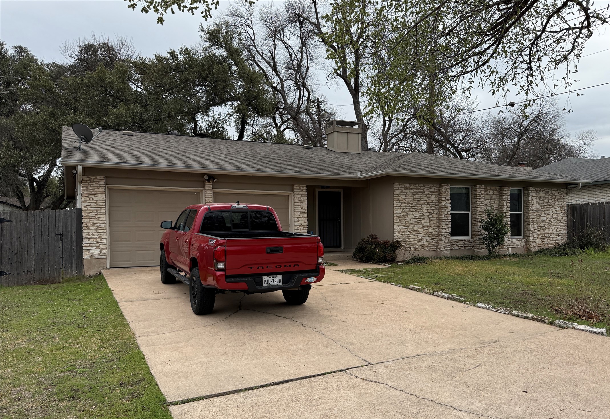7501 West Gate Boulevard Austin, TX 78745 - Photo 3 of 33 Ranch-style house with stone siding, an attached garage, concrete driveway, a chimney, and a shingled roof