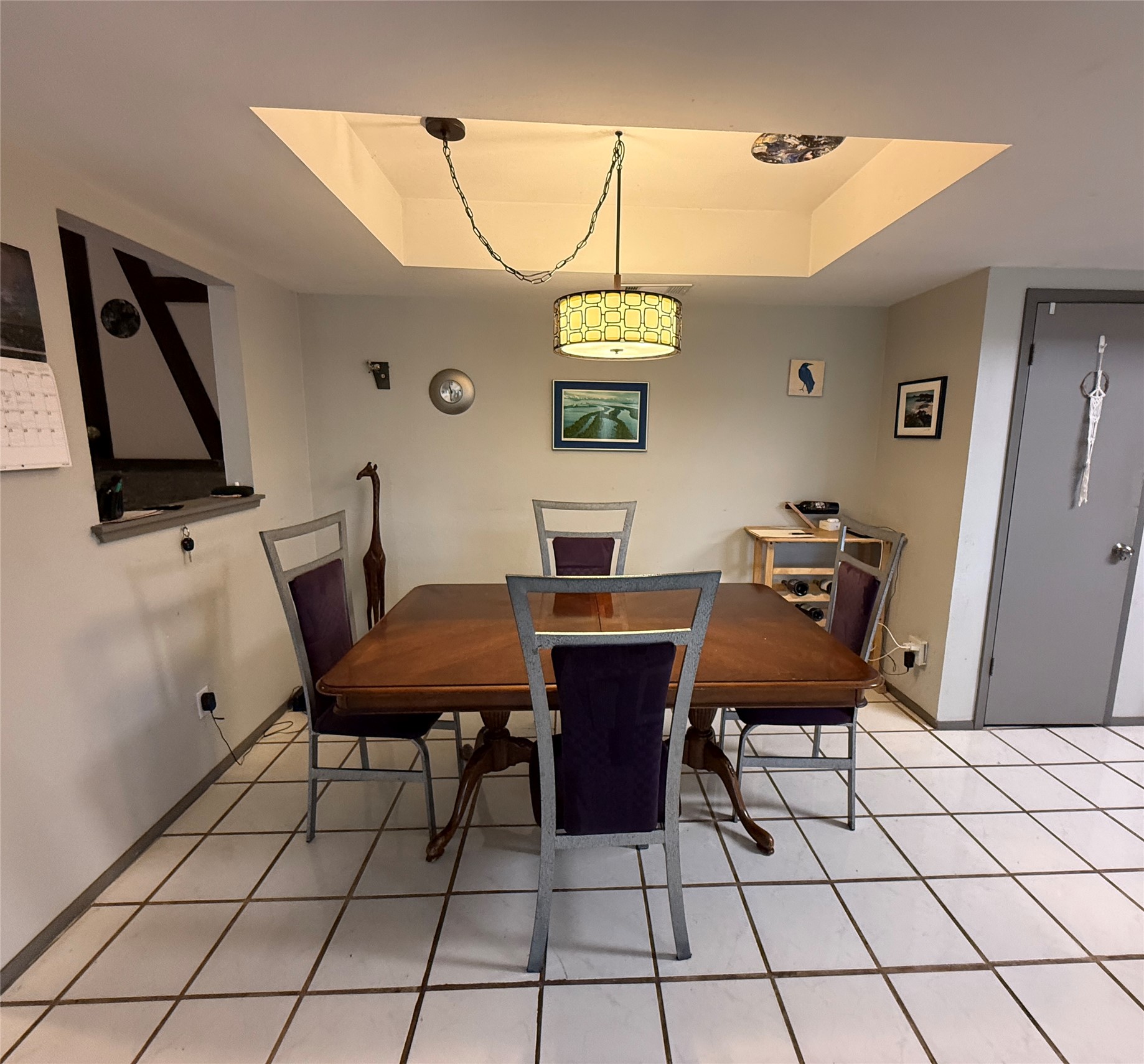 7501 West Gate Boulevard Austin, TX 78745 - Photo 5 of 33 Dining space featuring a raised ceiling and light tile patterned flooring