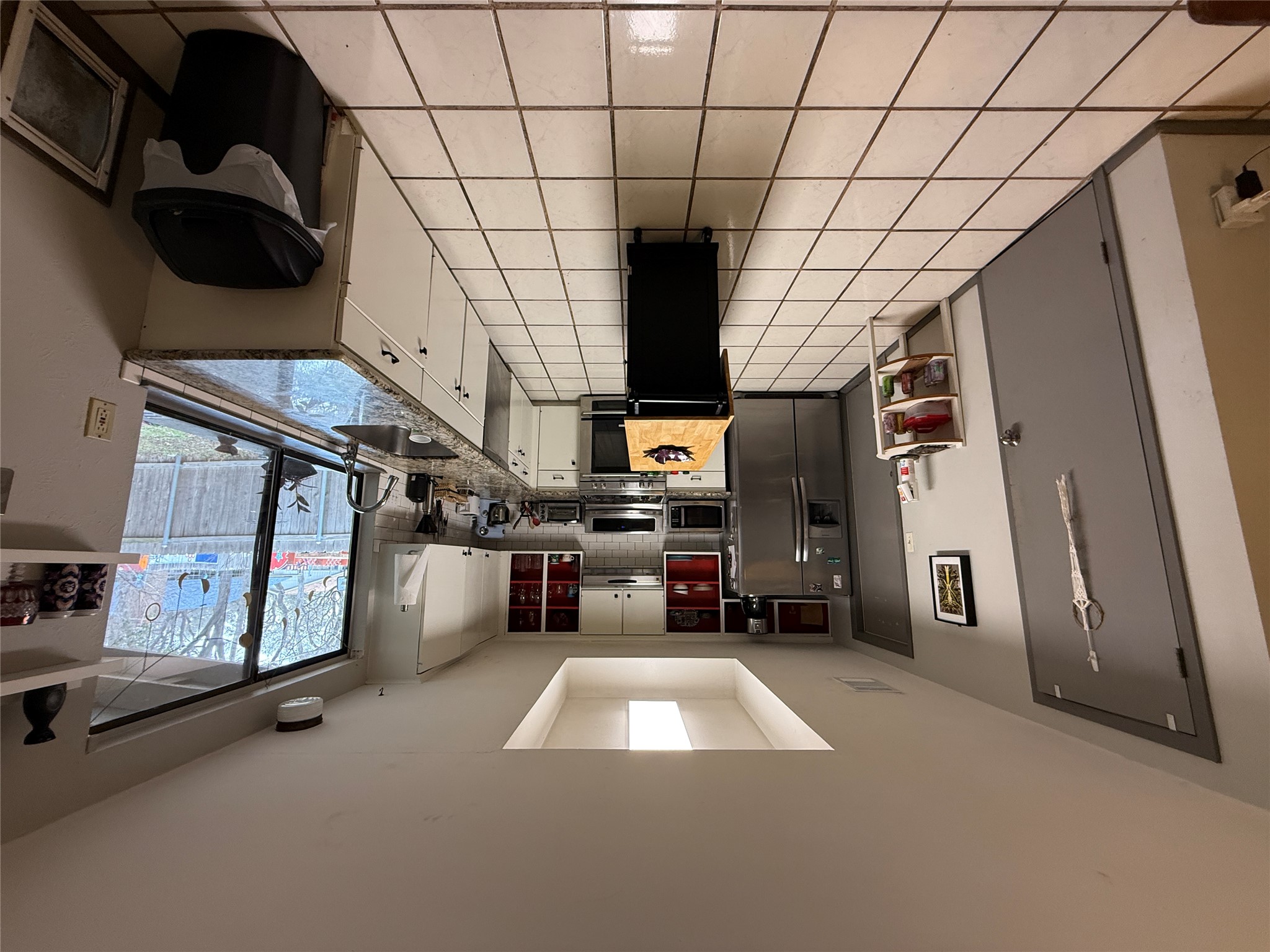 7501 West Gate Boulevard Austin, TX 78745 - Photo 6 of 33 Kitchen with stainless steel appliances, white cabinets, a tray ceiling, backsplash, and open shelves