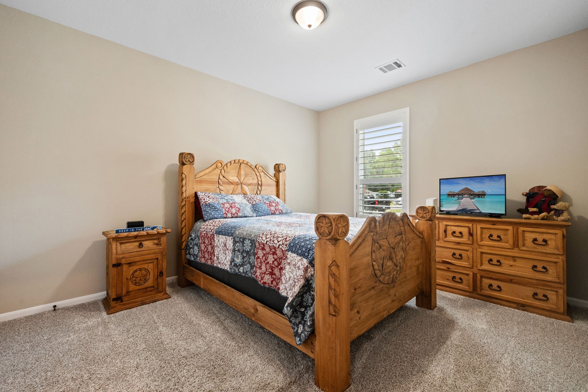 3004 Tyler Street Dayton, TX 77535 - Photo 23 of 34 a bedroom with a bed and a dresser