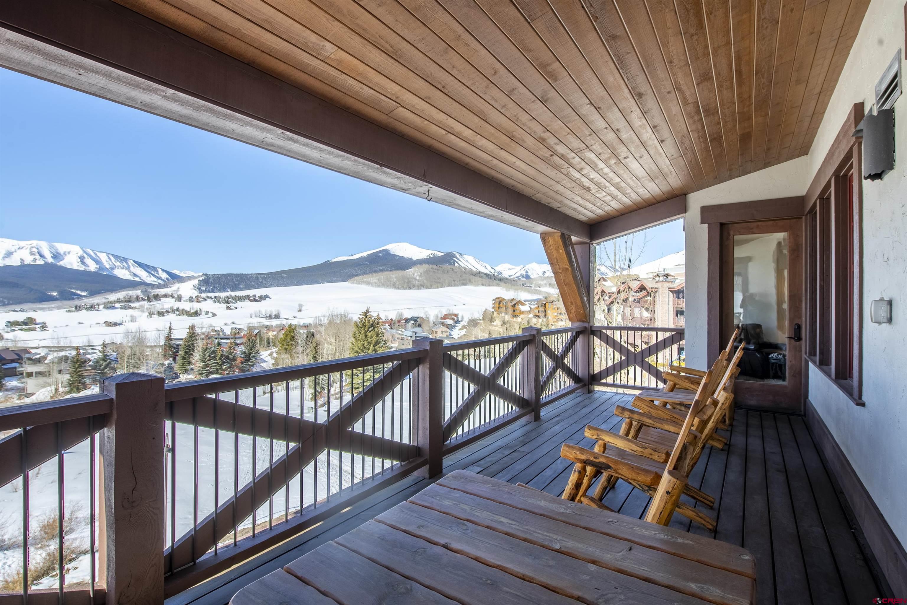 14 Hunter Hill Road, Unit C302 Crested Butte, CO 81225 - Photo 13 of 32 a view of a balcony with furniture and wooden floor