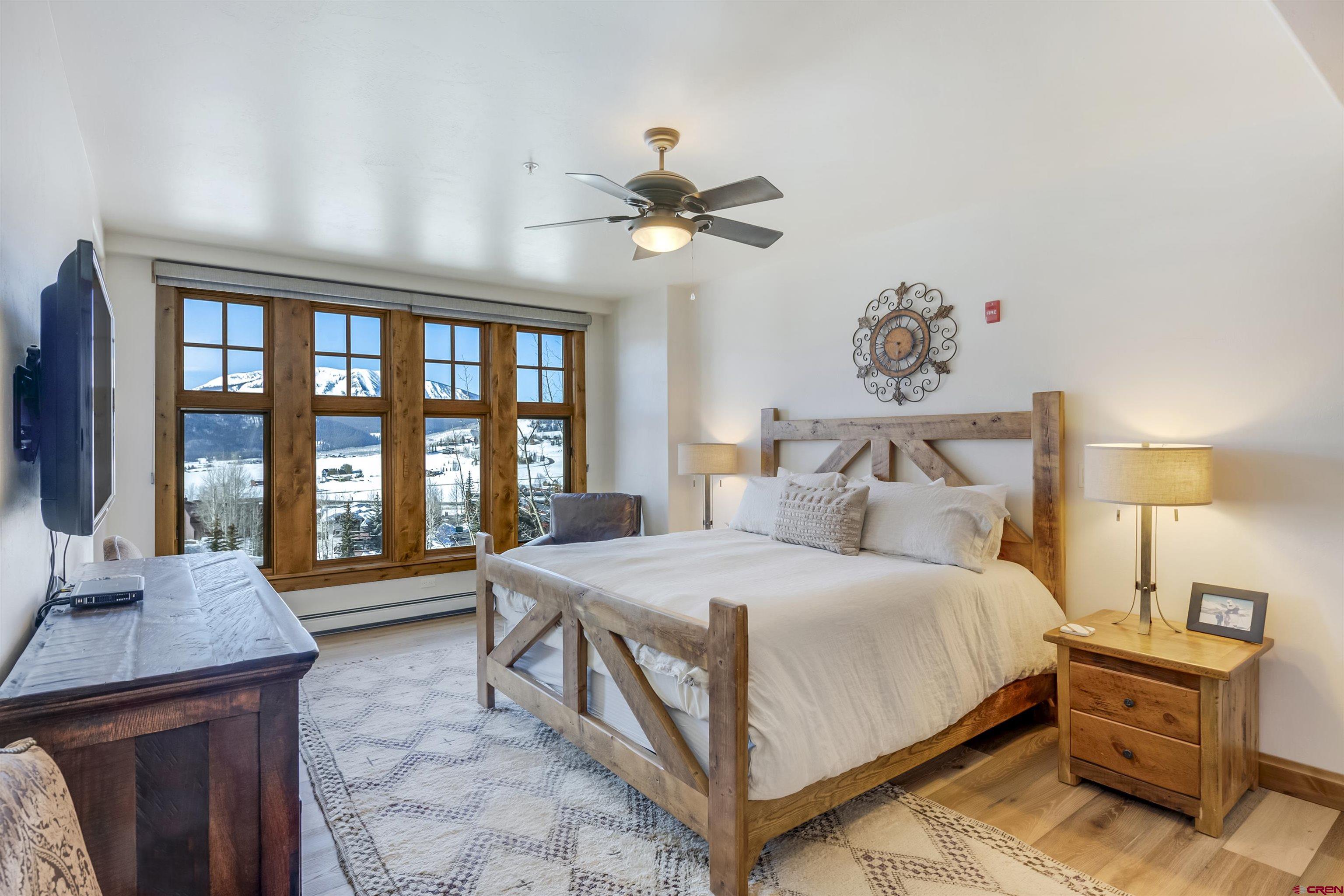 14 Hunter Hill Road, Unit C302 Crested Butte, CO 81225 - Photo 15 of 32 a bedroom with a bed and a table in it