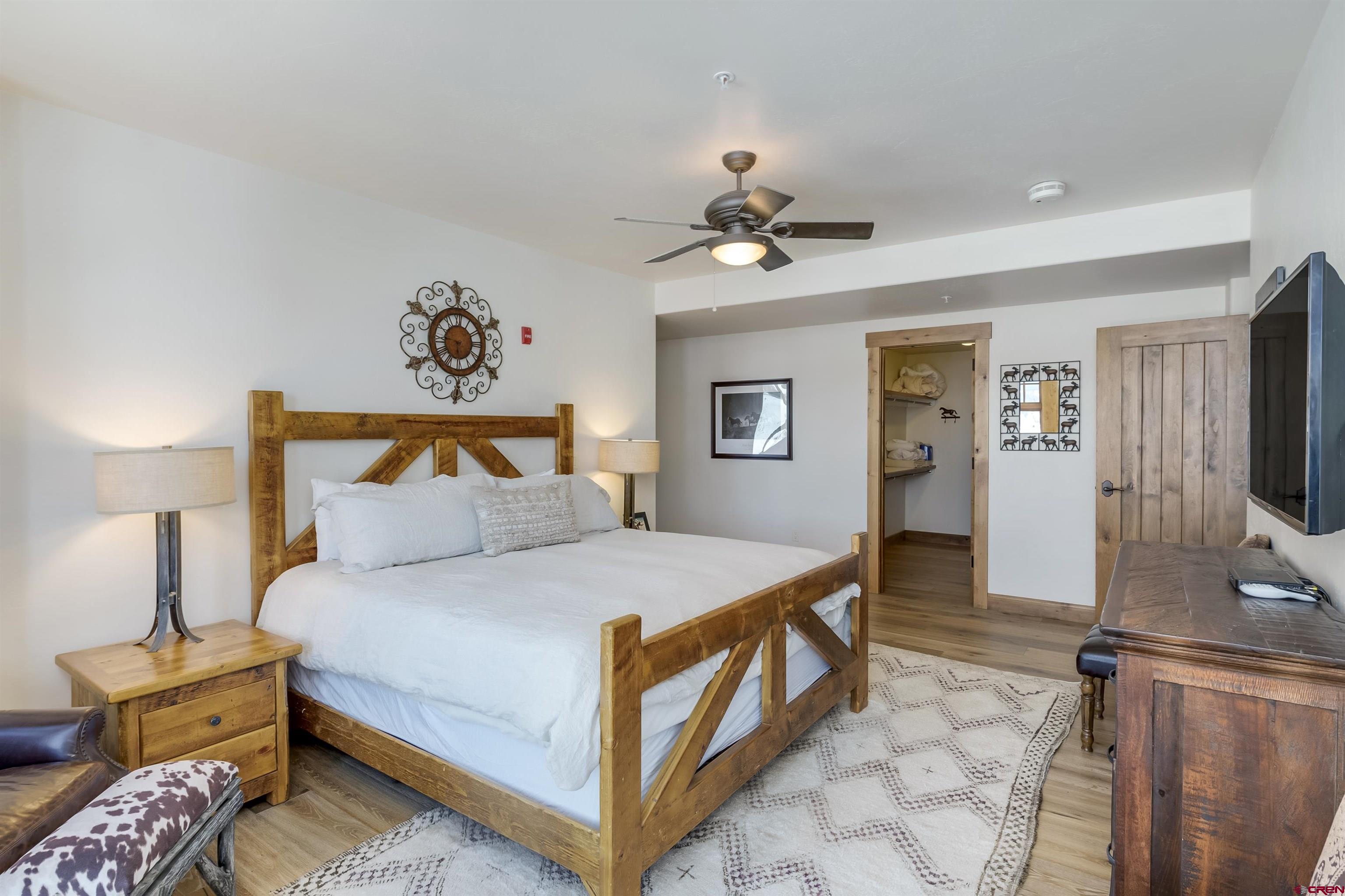 14 Hunter Hill Road, Unit C302 Crested Butte, CO 81225 - Photo 16 of 32 a bedroom with a bed and a tv on the dresser