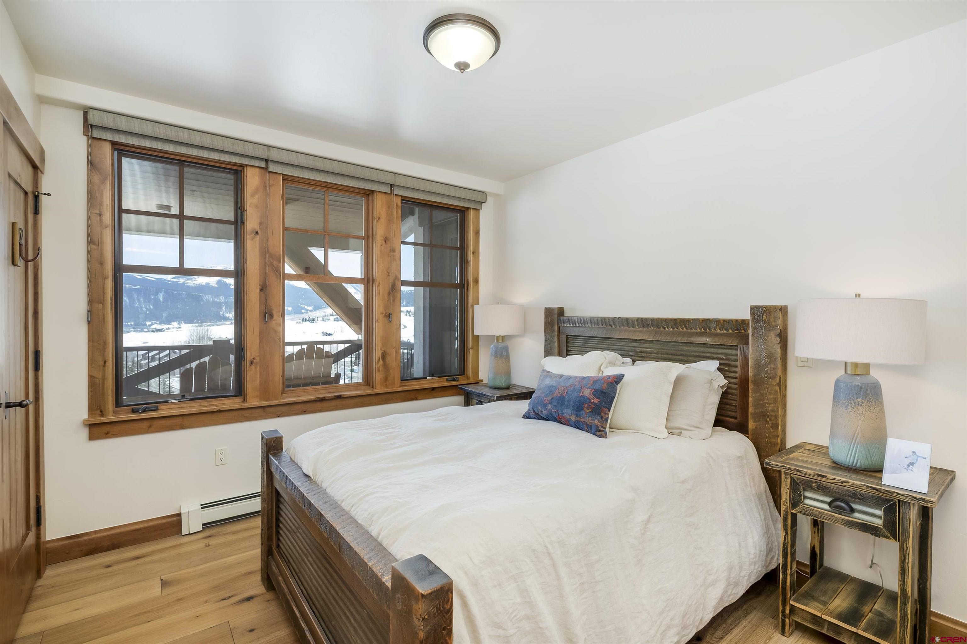 14 Hunter Hill Road, Unit C302 Crested Butte, CO 81225 - Photo 18 of 32 a bedroom with a large bed and a window