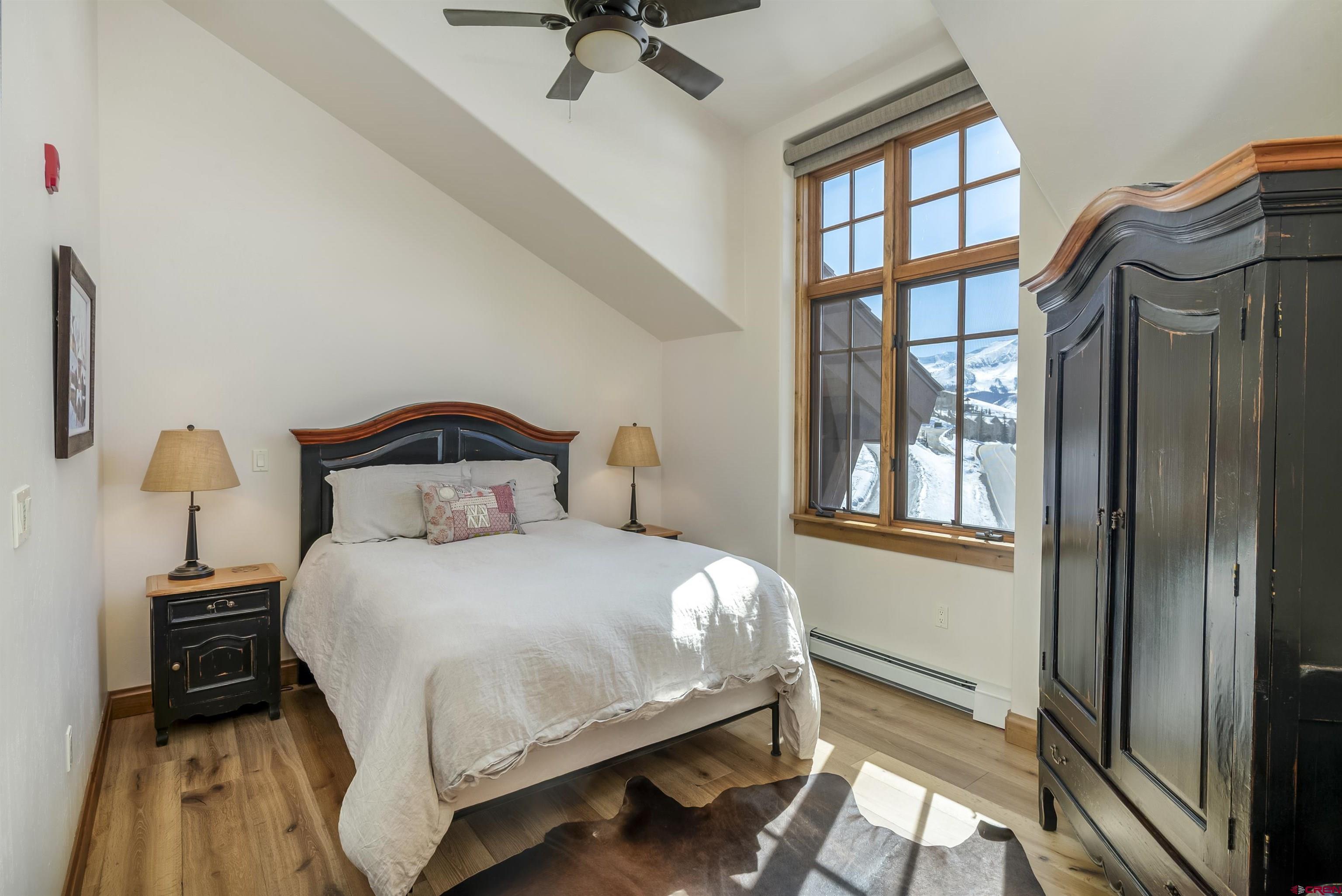 14 Hunter Hill Road, Unit C302 Crested Butte, CO 81225 - Photo 20 of 32 a bedroom with a bed and a window