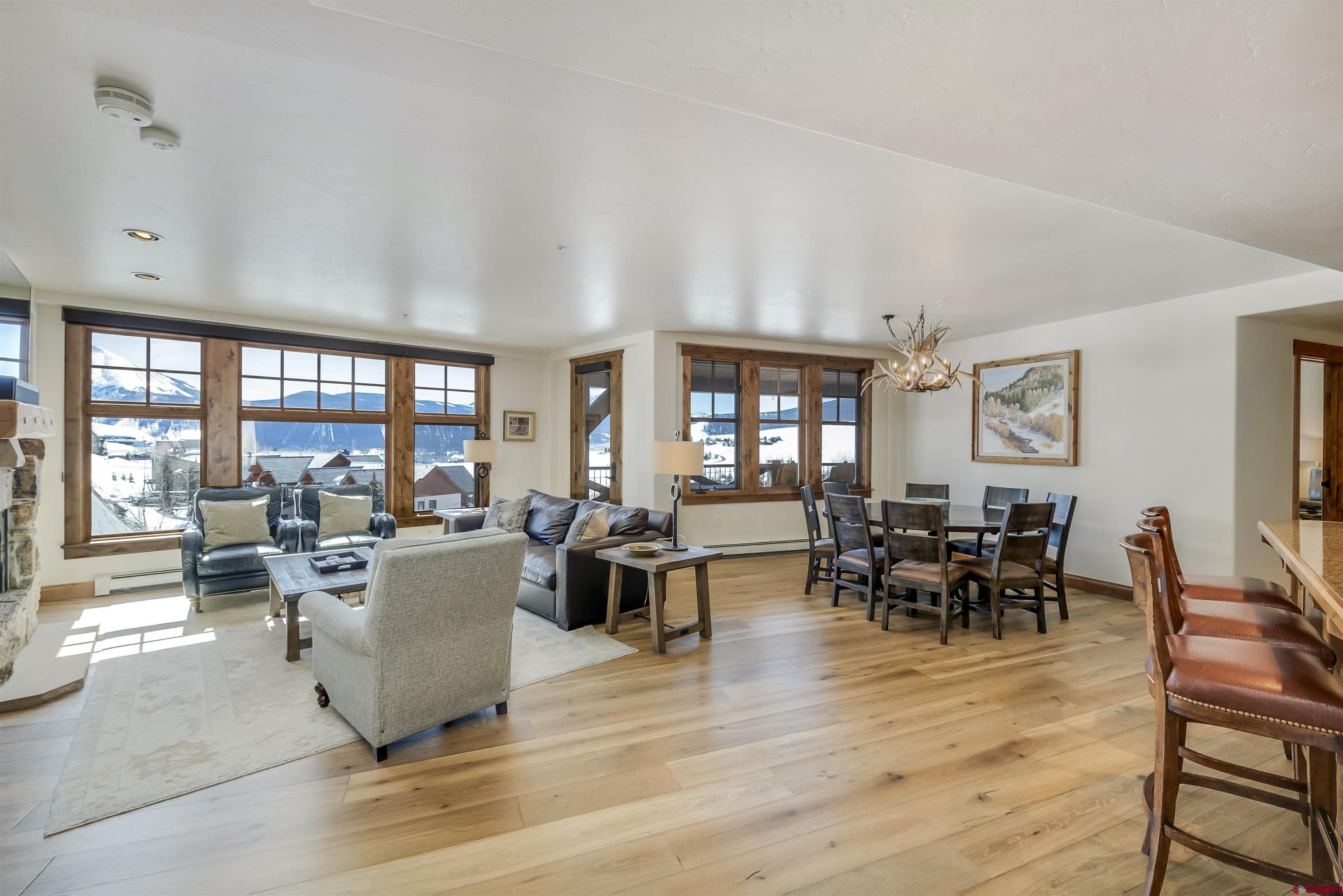 14 Hunter Hill Road, Unit C302 Crested Butte, CO 81225 - Photo 6 of 32 a living room with furniture large window and flat screen tv
