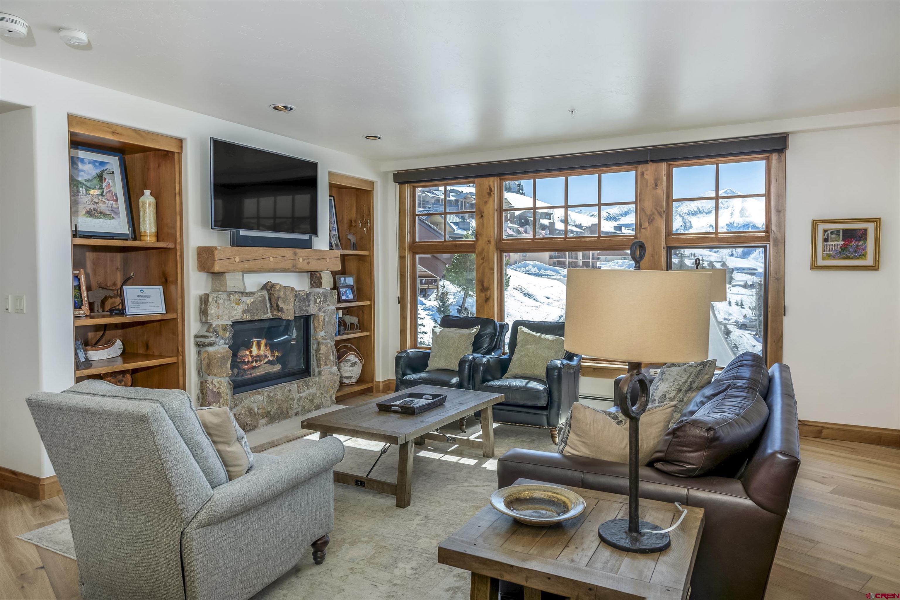 14 Hunter Hill Road, Unit C302 Crested Butte, CO 81225 - Photo 7 of 32 a living room with furniture fireplace and a flat screen tv