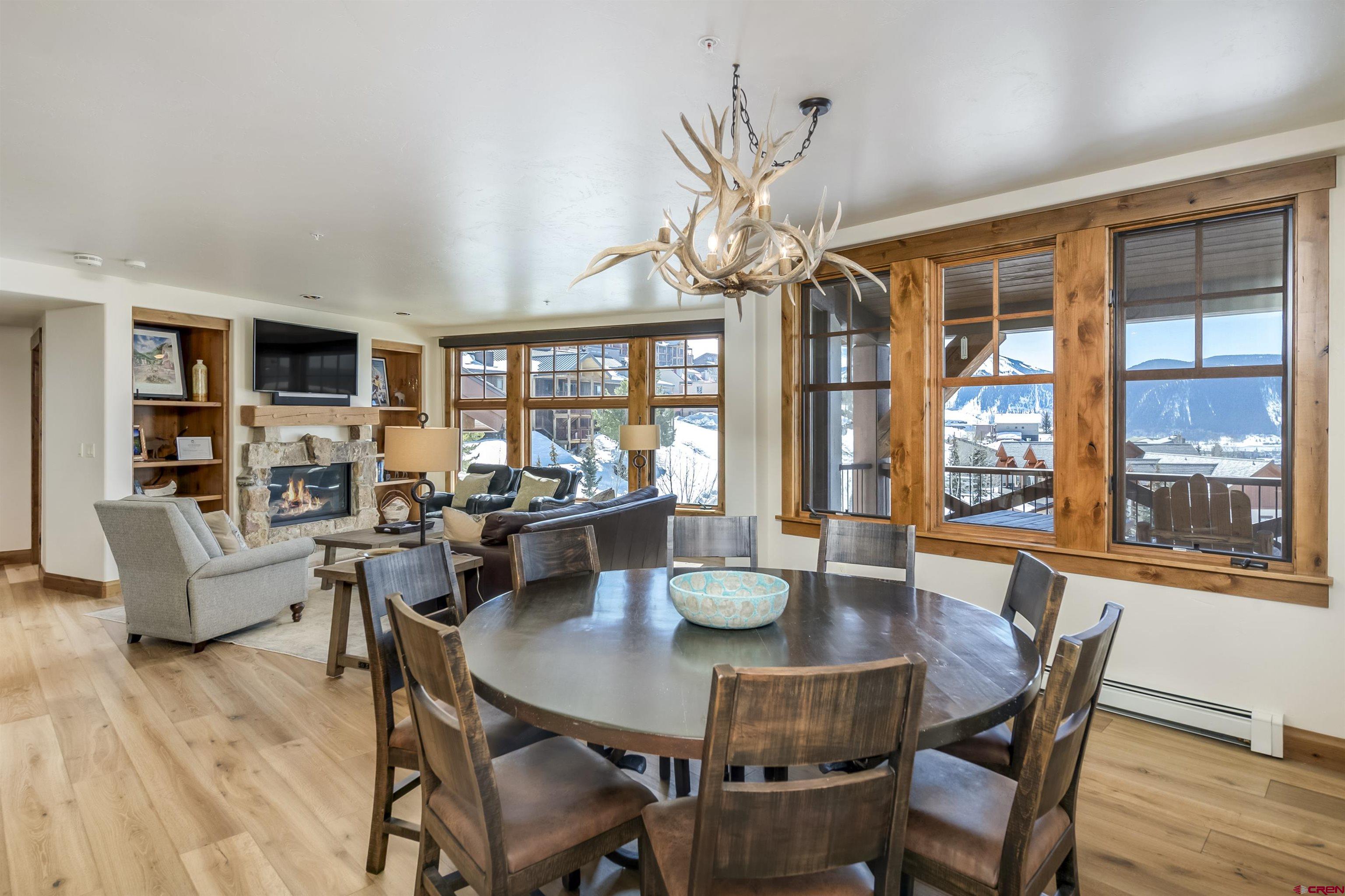14 Hunter Hill Road, Unit C302 Crested Butte, CO 81225 - Photo 8 of 32 a view of a dining room with furniture window and wooden floor