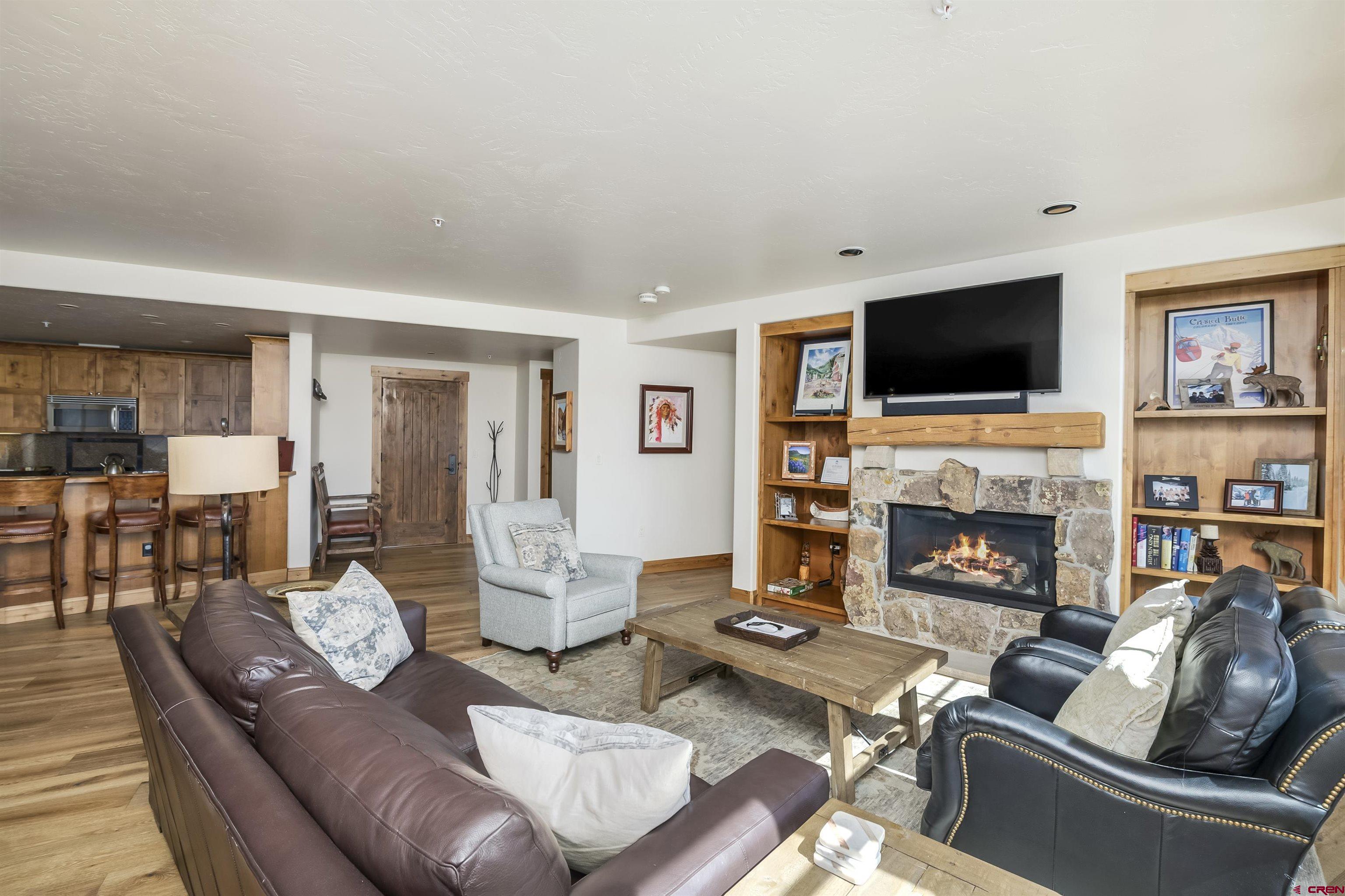 14 Hunter Hill Road, Unit C302 Crested Butte, CO 81225 - Photo 9 of 32 a living room with furniture fireplace and a flat screen tv