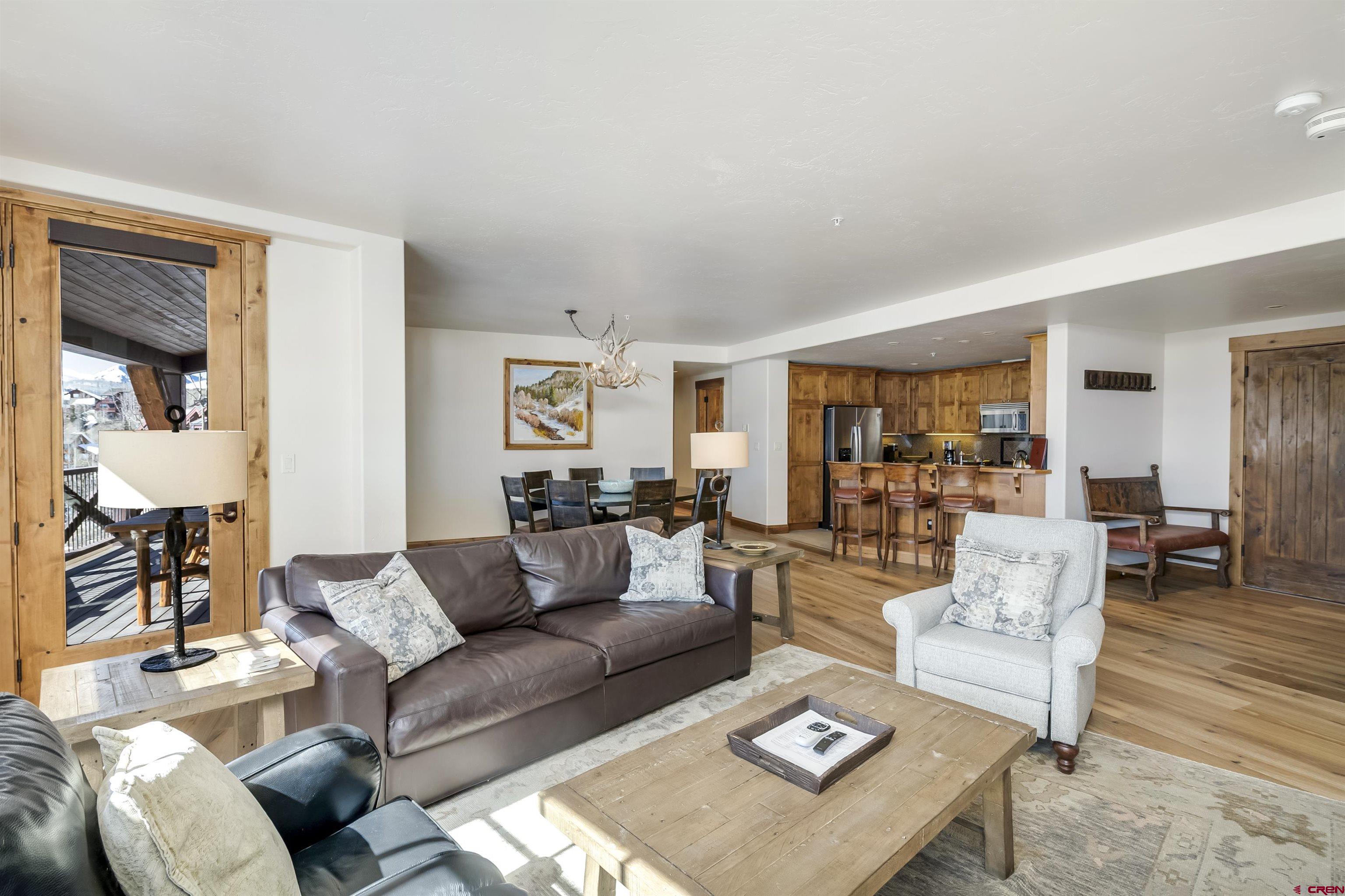14 Hunter Hill Road, Unit C302 Crested Butte, CO 81225 - Photo 10 of 32 a living room with furniture and a table