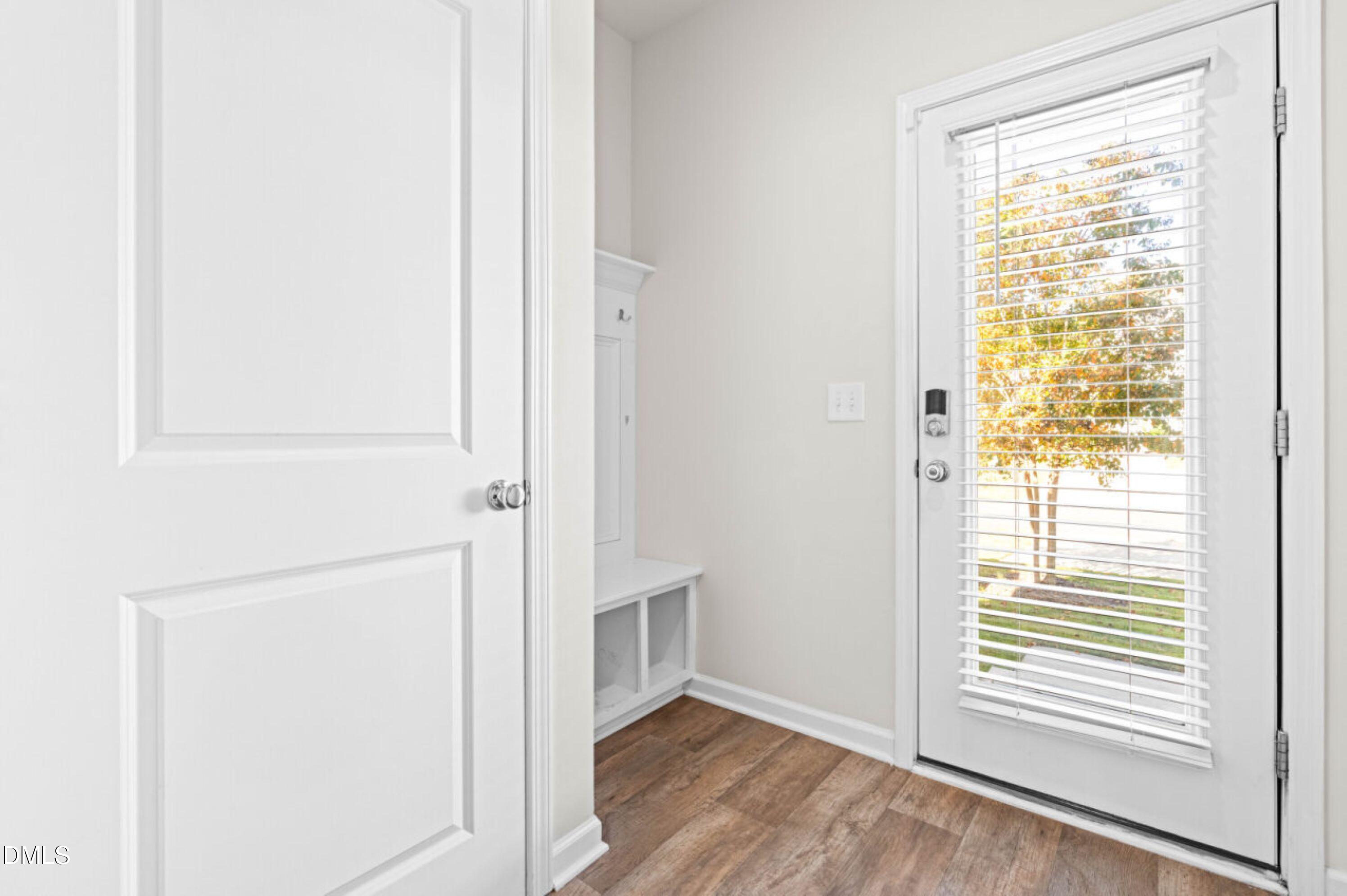 74 Liam Street Clayton, NC 27520 - Photo 15 of 33 a view of an empty room with wooden floor and a window