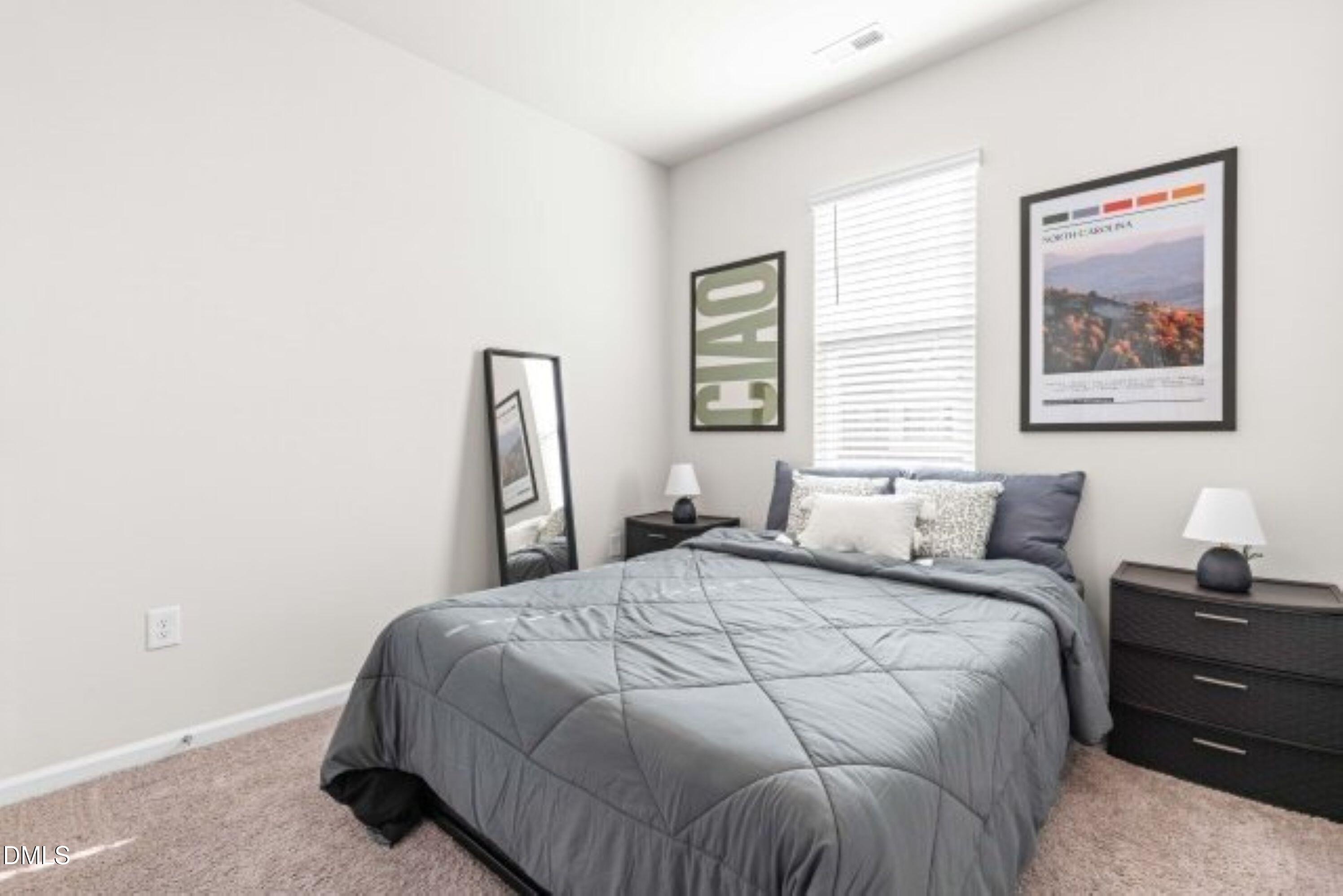 74 Liam Street Clayton, NC 27520 - Photo 25 of 33 a bedroom with a bed and a window