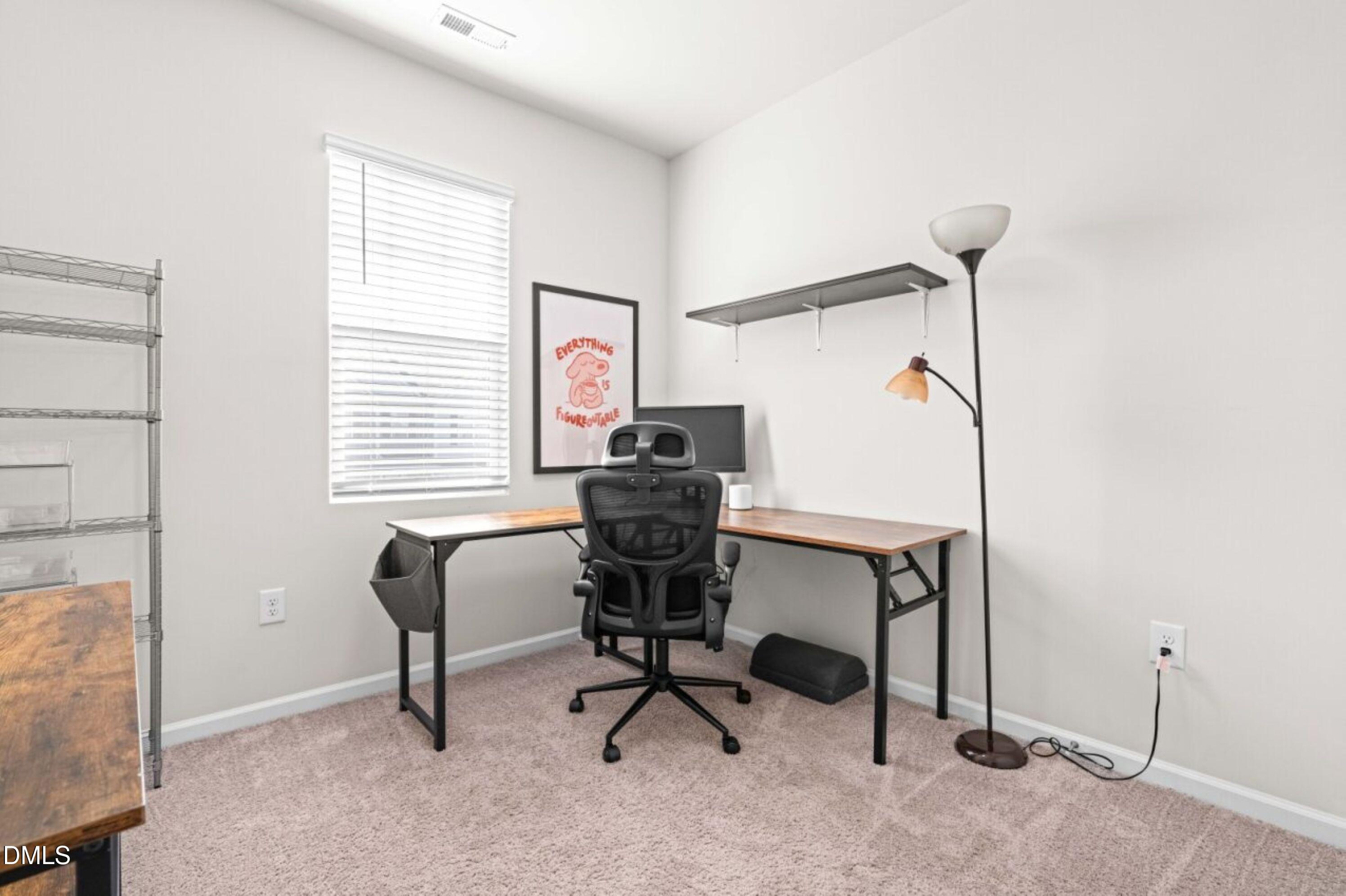74 Liam Street Clayton, NC 27520 - Photo 26 of 33 a view of a workspace with furniture and a window