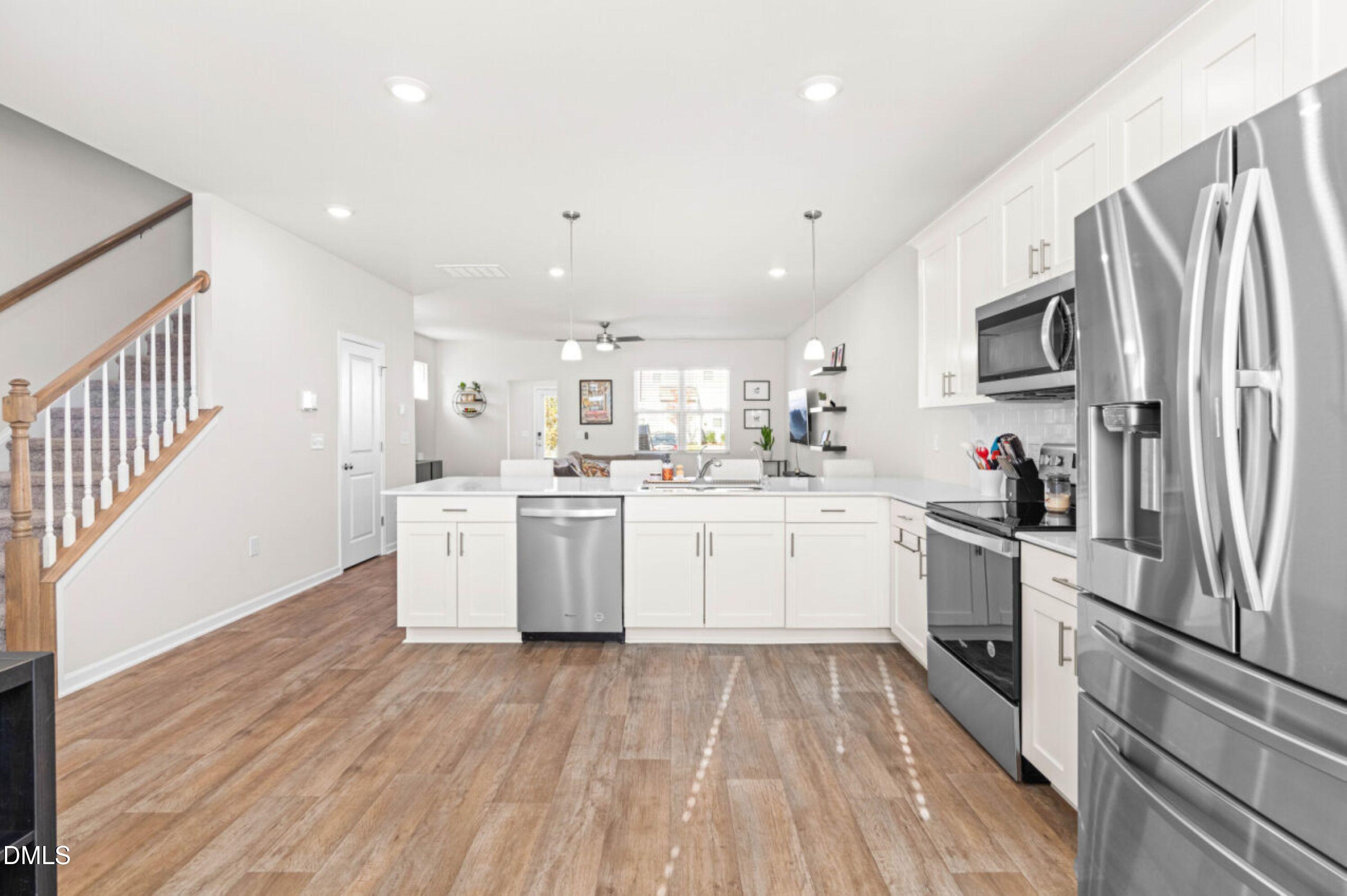 74 Liam Street Clayton, NC 27520 - Photo 8 of 33 a kitchen with stainless steel appliances a refrigerator sink and microwave