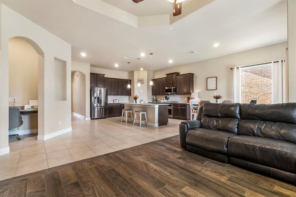 3610 Bastrop Street Melissa, TX 75454 - Photo 8 of 23 a view of kitchen with kitchen island microwave stove refrigerator and couches with wooden floor