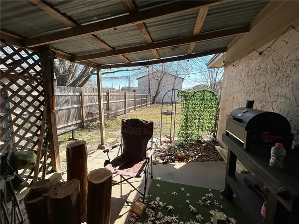 a view of a chairs and table in a patio