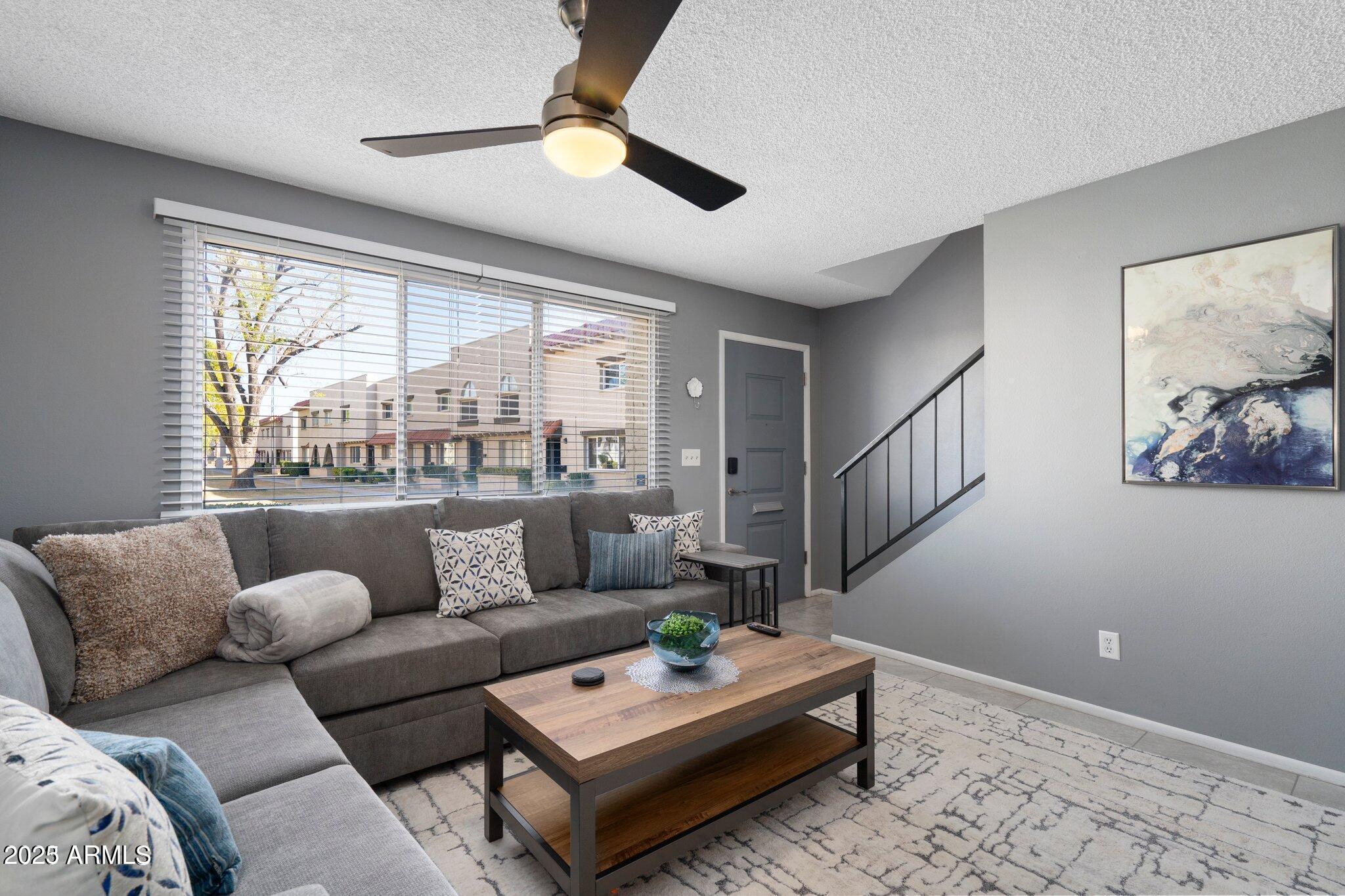 6921 East Osborn Road, Unit D Scottsdale, AZ 85251 - Photo 10 of 14 a living room with furniture and a large window