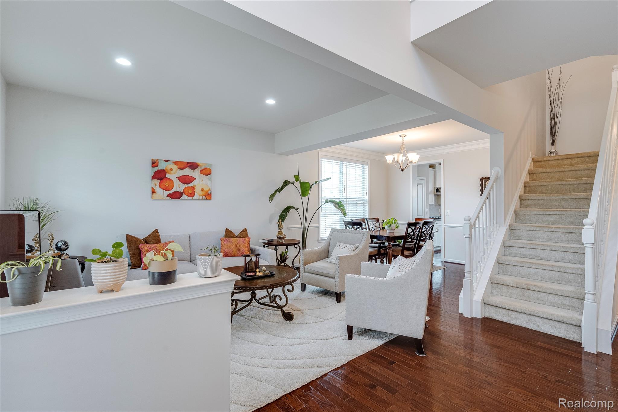 Living area featuring dark wood-type flooring and a chandelier