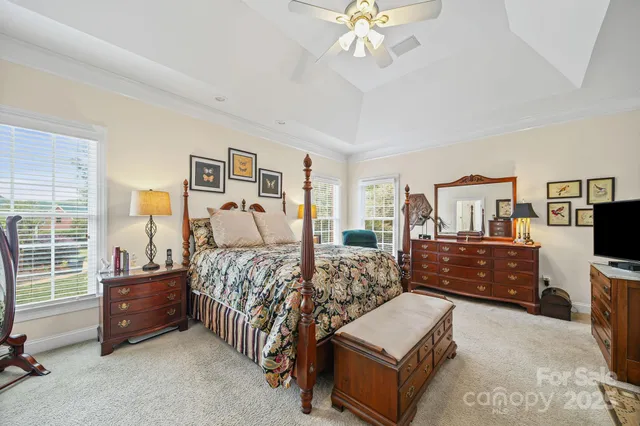 a bedroom with furniture and a flat screen tv