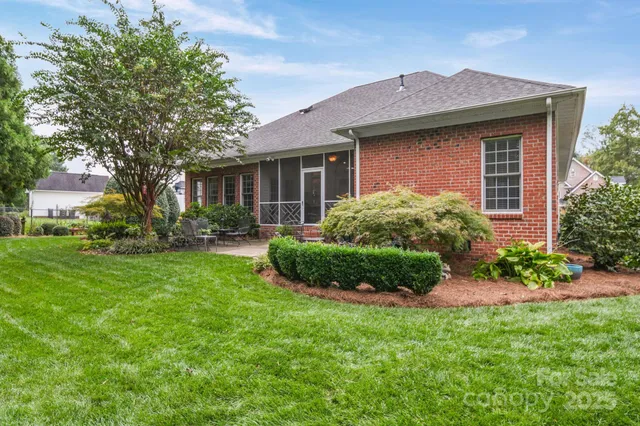 a view of a house with a yard and plants