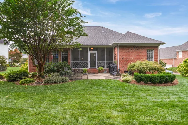 a view of a house with a yard and potted plants