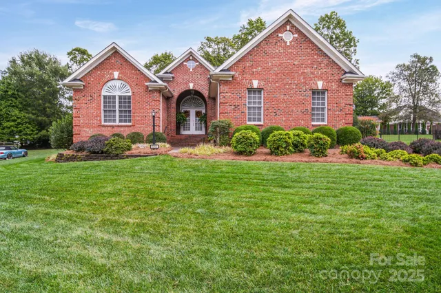 a front view of a house with a garden and plants