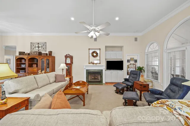 a living room with furniture fireplace and a window