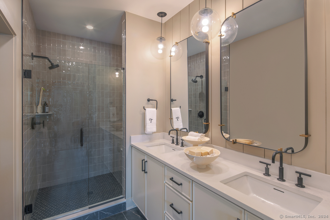 14 Whisper Rdg Way, Unit 46 Woodbridge, CT 06525 - Photo 6 of 14 a bathroom with a double vanity sink mirror and shower