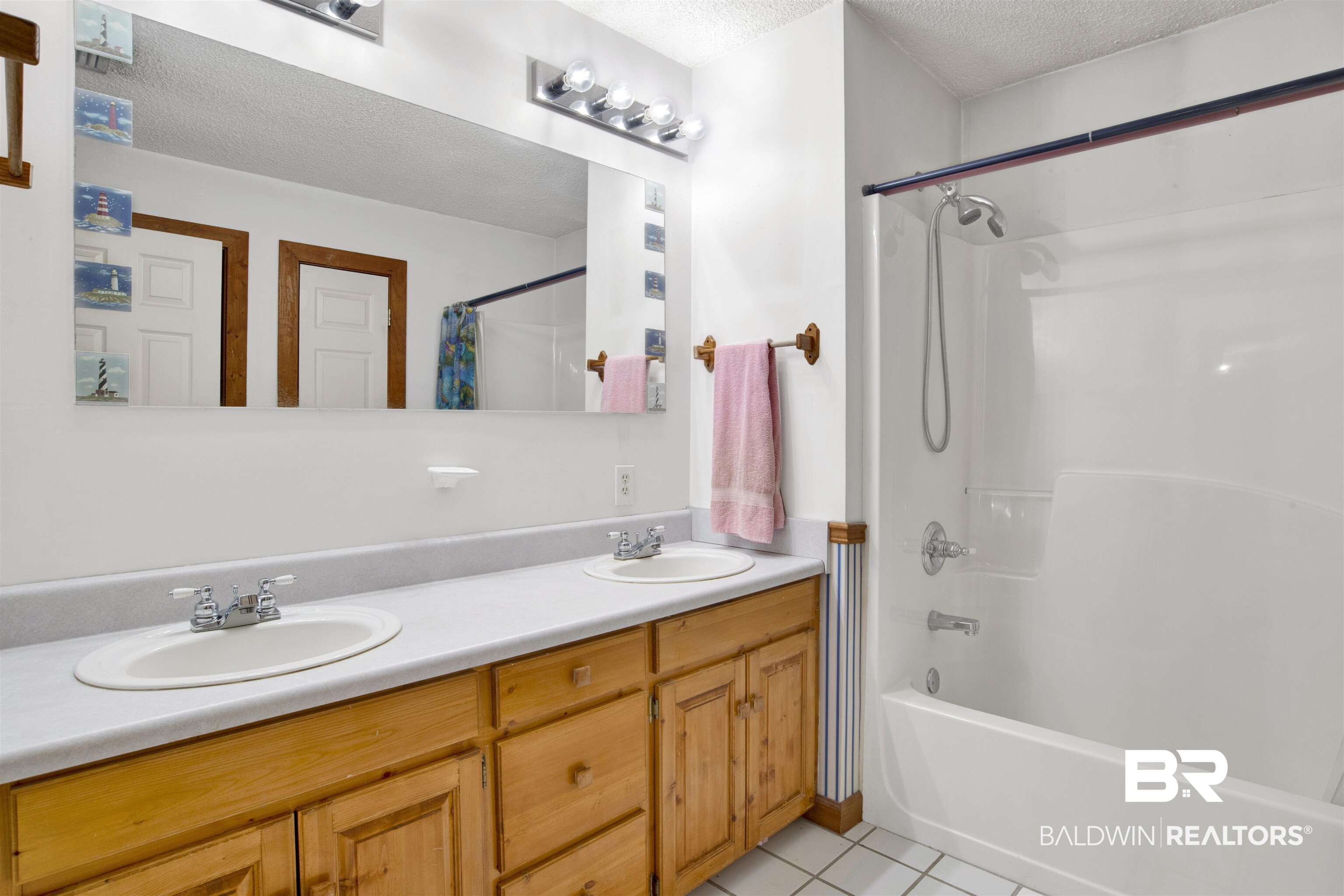 4890 Red Creek Road Semmes, AL 36575 - Photo 24 of 47 Bathroom with vanity, shower / tub combo with curtain, tile patterned floors, and a textured ceiling