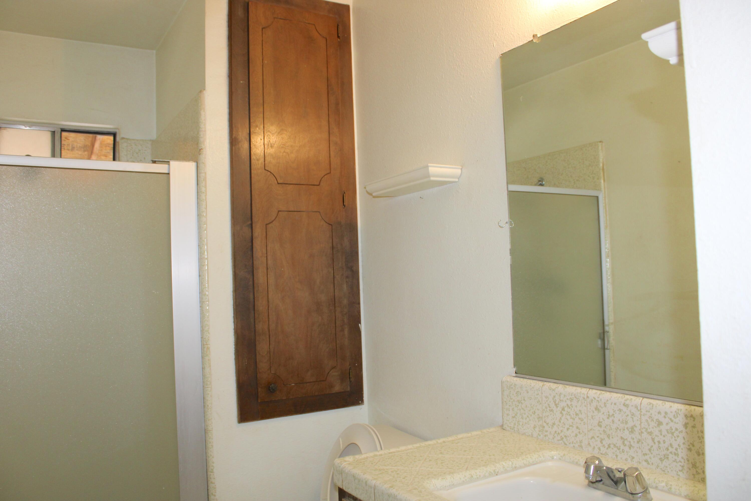 517 South R Street Tulare, CA 93274 - Photo 15 of 21 a bathroom with a sink and a mirror