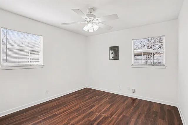 a view of wooden floor and a chandelier fan in a room
