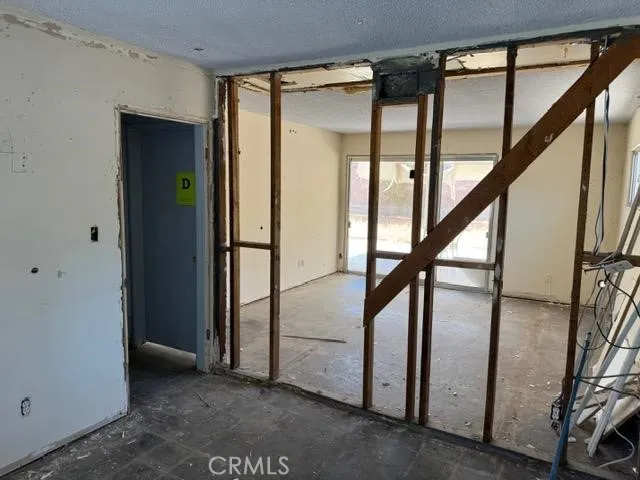 a view of a patio with table and chairs and potted plants