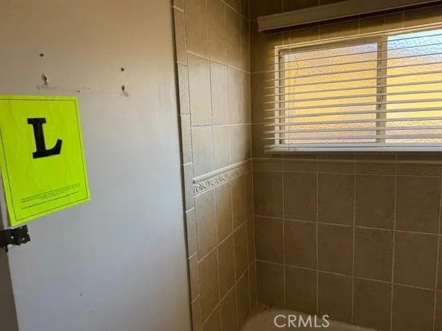 a bathroom with a window and a shower