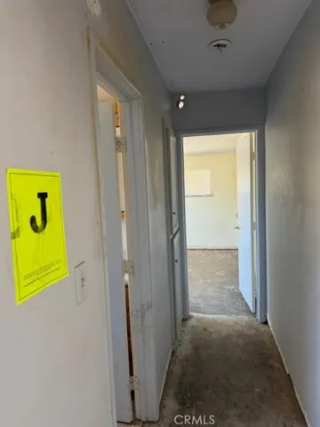 a bathroom with a granite countertop sink a toilet and a shower curtain