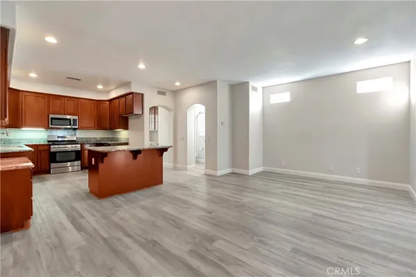a large kitchen with stainless steel appliances granite countertop a large counter top and a stove