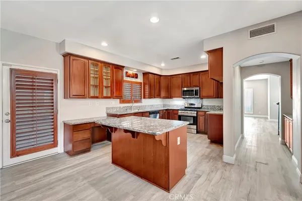 a kitchen with stainless steel appliances granite countertop a stove and a sink